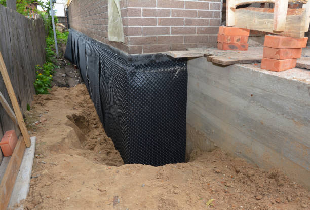 Happy homeowners after waterproofing job in Carthage